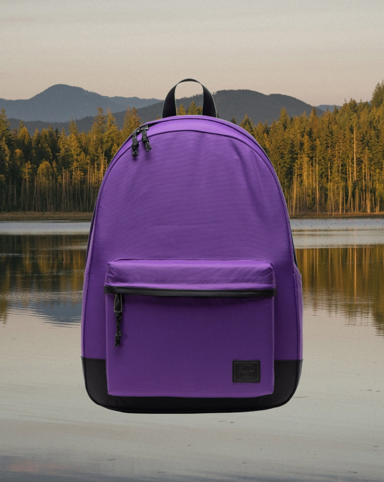 Herschel Supply Co. Classic XL Backpack in a solid deep purple Acai colorway, featuring a front storage pocket and a clean, minimalist design.