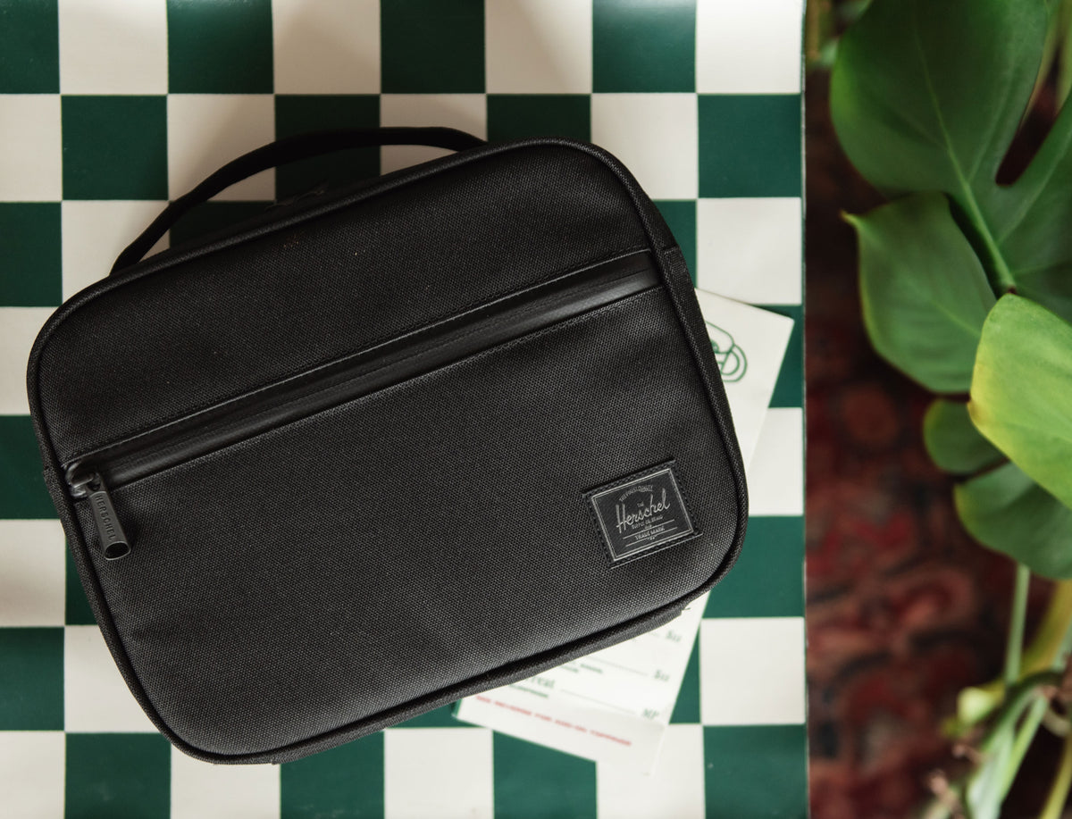 Herschel Supply Co. Pop Quiz Lunch Box in Black Tonal, an insulated, durable lunch bag featuring a clean, minimalist design with tonal detailing.