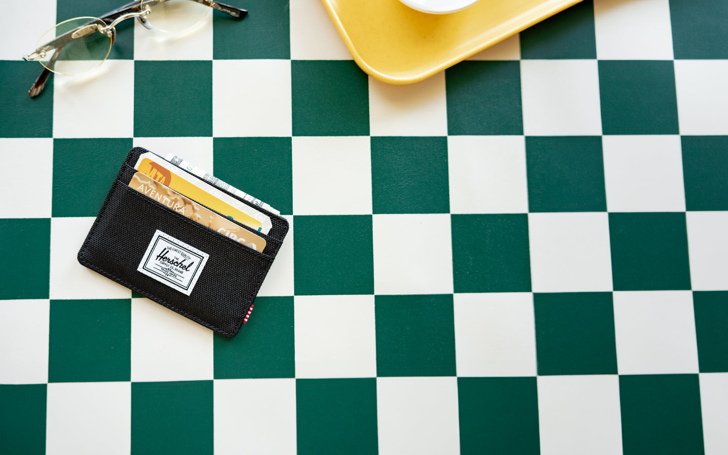 Herschel Supply Co. Charlie Cardholder in classic black, showcasing its slim design, multiple card slots, and signature striped liner.