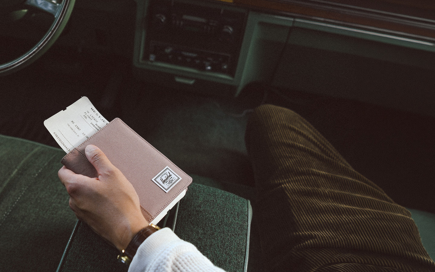 Herschel Supply Co. Raynor Passport Holder in Ash Rose pink, laid flat to show its clean exterior design and compact shape.