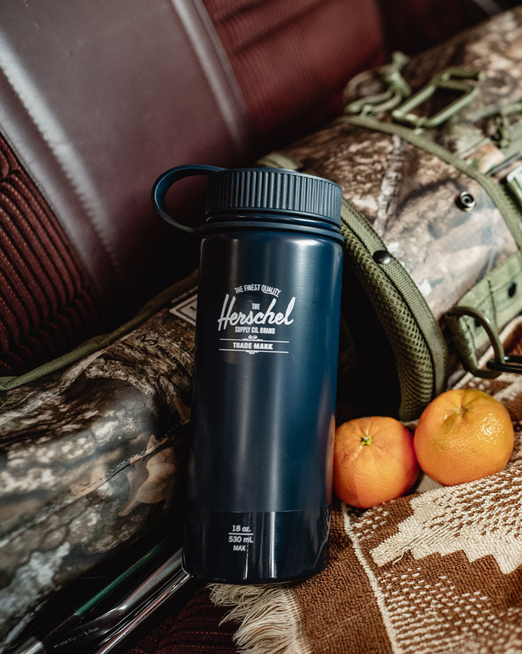 Herschel Supply Co. 18oz insulated water bottle in a sleek navy blue color with a glossy finish.