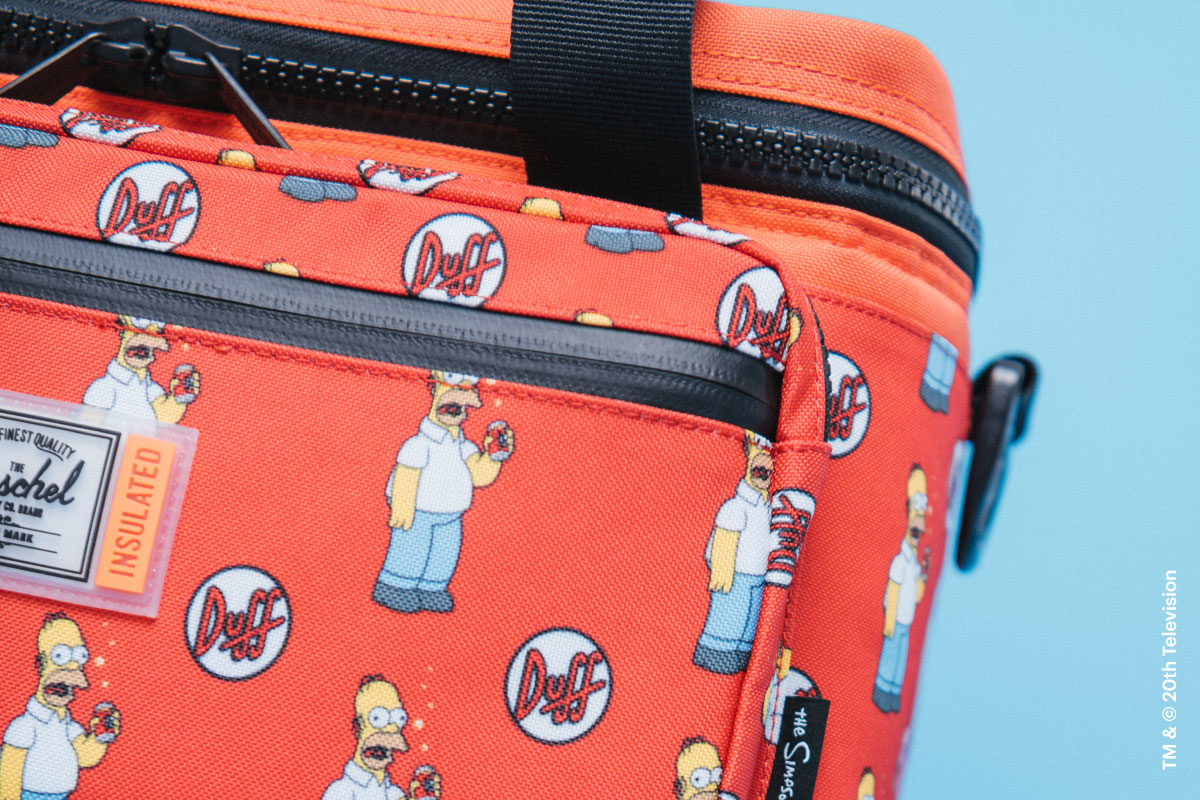 A shot of the front pocket of the Duff Beer Pop Quiz Cooler 12 Pack Insulated Simpsons from The Simpsons™ x Herschel Supply Company collection showing it's waterproof zippers