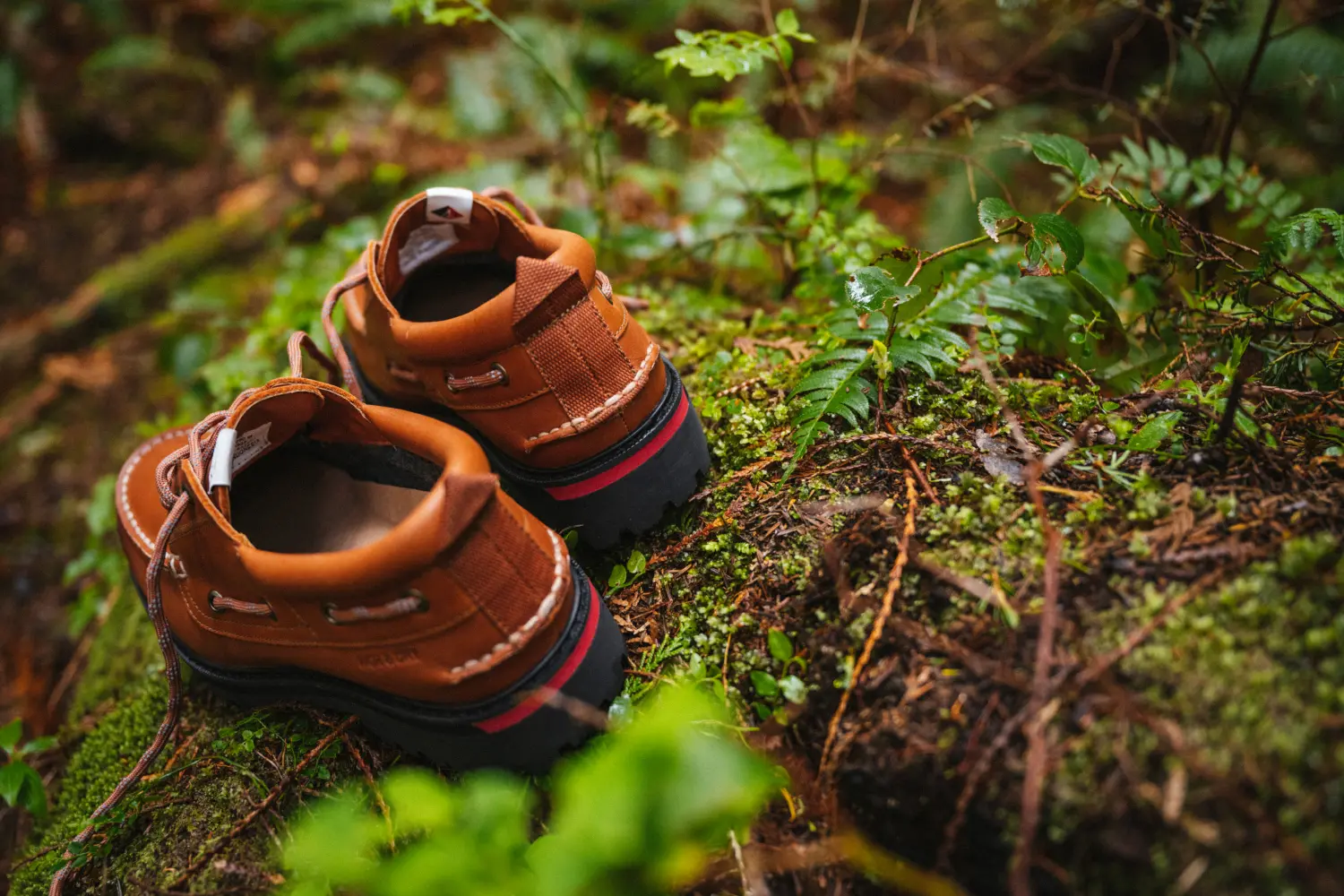 The Sperry x Herschel Authentic Original 3-Eye Lug Shoe in Saddle on mossy ground