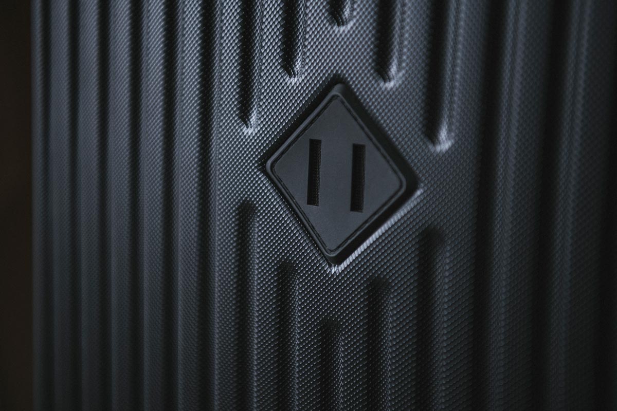 Embossed rubber diamond on the front of the Herschel Trade Luggage Medium suitcase